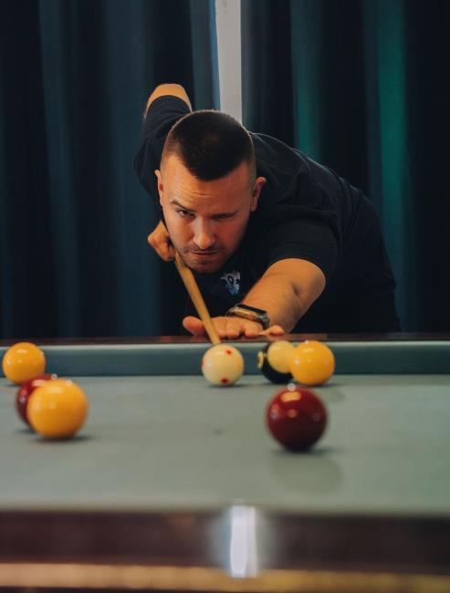 A fully-focussed Dan at a pool table